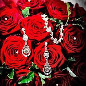 fwthumbBrides red rose bouqeut with earrings.jpg